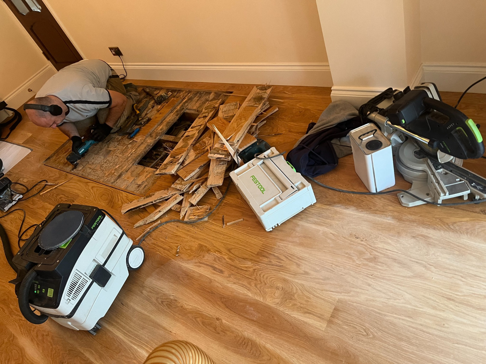 Wood Floor Staining in Carshalton – engineered oak plank floor repair with damaged boards removed before colour matching and finishing.