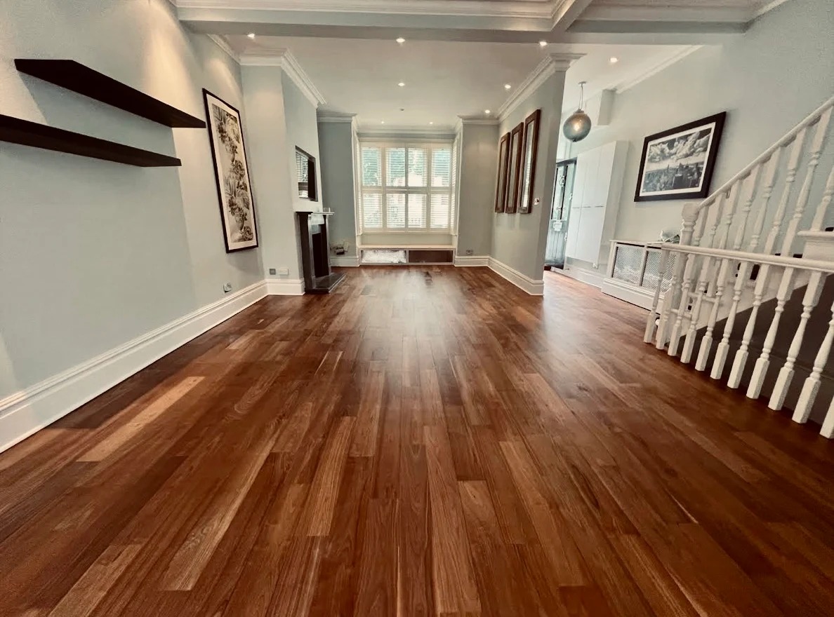 Wood Floor Staining in Carshalton – walnut hardwood plank floor in a bright lounge, professionally stained and sealed to a warm satin sheen.
