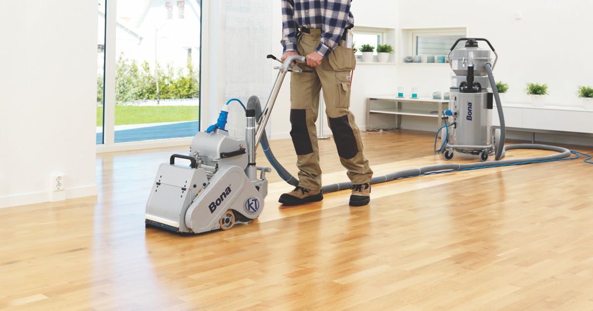 Commercial Floor Sanding in Carshalton on a light oak hardwood office floor using a dust-free belt sanding machine for a clean, quiet finish.